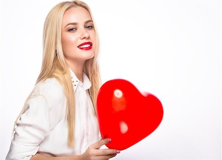 Love and valentines day,  woman holding hearts smiling cute. Portrait of Beautiful woman with bright makeup and red heart in hand Photographie de stock - Aubaine LD & Abonnement, Code: 400-08612913