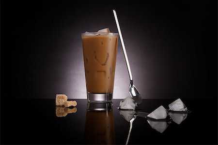 Delicious ice coffee with melting ice cubes and brown sugar on dark background. Culinary gourmet luxurious coffee drinking. Stockbilder - Microstock & Abonnement, Bildnummer: 400-08624380