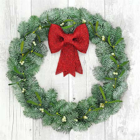 red ribbon and plant - Christmas wreath with red bow decoration, mistletoe and snow covered blue spruce fir over distressed white wood background. Stock Photo - Budget Royalty-Free & Subscription, Code: 400-08627920