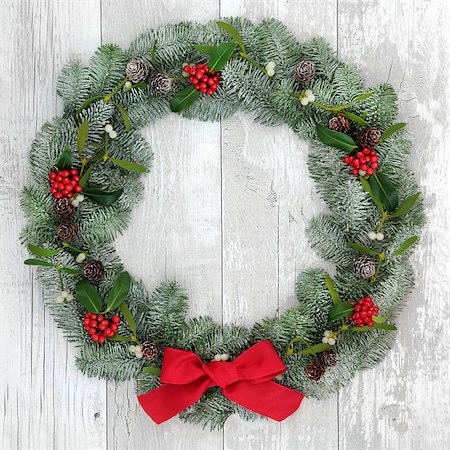 red ribbon and plant - Traditional christmas wreath decoartion with holly, fir and mistletoe over distressed white wood front door background. Stock Photo - Budget Royalty-Free & Subscription, Code: 400-08628000
