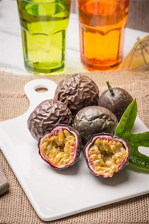 Passion fruits on white ceramic tray on wooden table background. Stock Photo - Budget Royalty-Free & Subscription, Code: 400-08620358