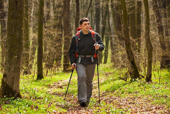 Hiker - man hiking in forest. Male hiker looking to the side walking in forest. Caucasian male model outdoors in nature. Stock Photo - Royalty-Free, Artist: aleksey_rezin, Image code: 400-08620731