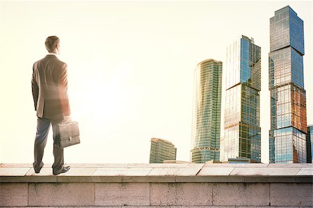 Businessman standing on roof and looking at sunrise, rear view Stock Photo - Budget Royalty-Free & Subscription, Code: 400-08622096