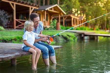 father and son fishing dock lake - Dad and son fishing on the lake Stock Photo - Budget Royalty-Free & Subscription, Code: 400-08623575