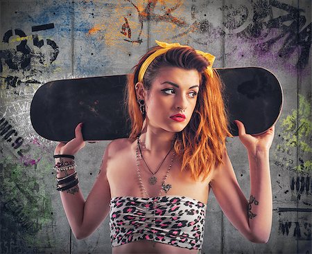 Tattooed girl with skate and murals background Stockbilder - Microstock & Abonnement, Bildnummer: 400-08668620