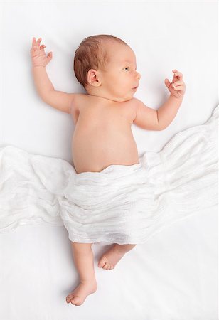 Cute newborn baby lying on bed under a blanket Stock Photo - Budget Royalty-Free & Subscription, Code: 400-08668737