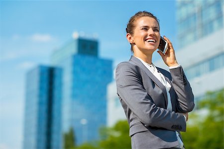 simsearch:400-07106831,k - Into the ultra-modern business trends. Smiling business woman in modern office district talking cellphone Stockbilder - Microstock & Abonnement, Bildnummer: 400-08669033