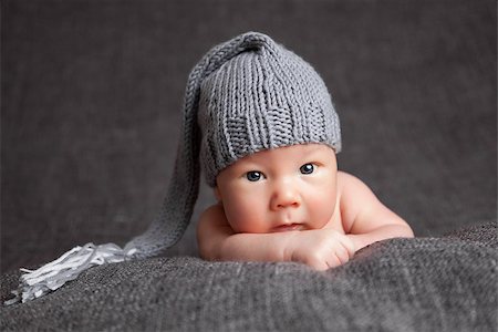 Beautiful newborn baby wearing a cute grey hat Stock Photo - Budget Royalty-Free & Subscription, Code: 400-08669353