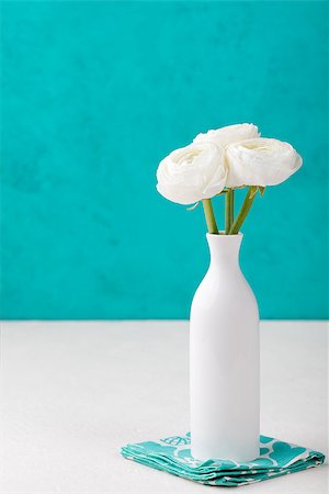 White ranunculus flowers in a ceramic vase Blue background Copy space Photographie de stock - Aubaine LD & Abonnement, Code: 400-08669428