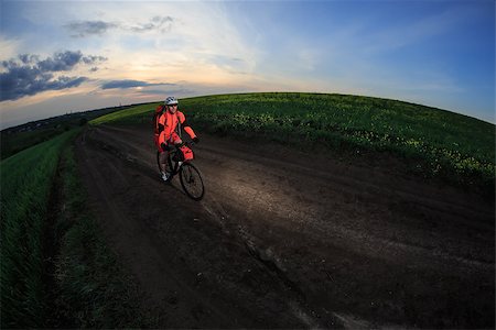 simsearch:400-05681317,k - Man on mountain bike rides on the trail on a beautiful sunset. Wide view Stock Photo - Budget Royalty-Free & Subscription, Code: 400-08678633