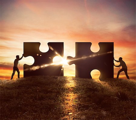 Men push two puzzle pieces at sunset Stock Photo - Budget Royalty-Free & Subscription, Code: 400-08670131