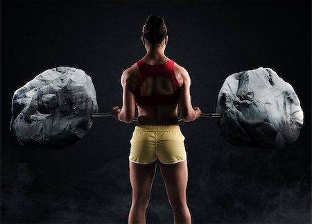 simsearch:400-08505882,k - Muscular woman raises two big boulders with a barbell Stock Photo - Budget Royalty-Free & Subscription, Code: 400-08670252