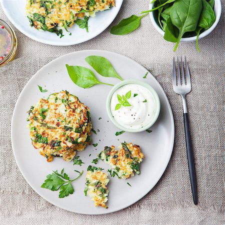 Cabbage and spinach pancakes with yogurt dressing with fresh herbs Top view Photographie de stock - Aubaine LD & Abonnement, Code: 400-08671085