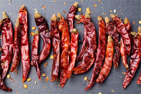 Dried red chili peppers on slate background Top view Copy space. Photographie de stock - Aubaine LD & Abonnement, Code: 400-08673334
