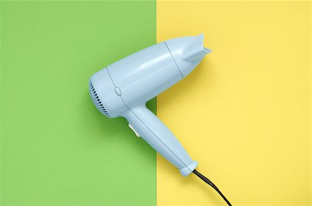 Blue hair dryer on green and yellow paper background Stock Photo - Budget Royalty-Free & Subscription, Code: 400-08673668