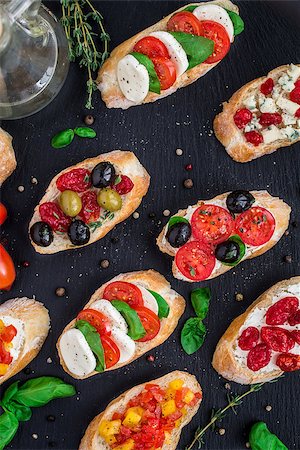 sandwich rustic table - Italian bruschetta with cherry tomatoes, herbs, olives, mozzarella on toasted crusty ciabatta bread Stock Photo - Budget Royalty-Free & Subscription, Code: 400-08694098