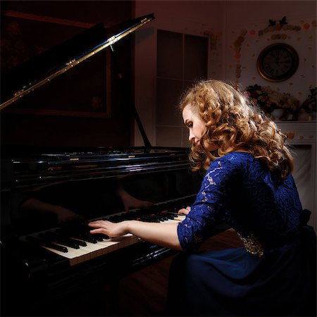 simsearch:400-09115438,k - Young woman musician sitting in front of grand piano and plays music. Foto de stock - Super Valor sin royalties y Suscripción, Código: 400-08694427