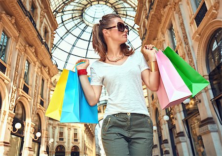 Discover most unexpected trends in Milan. Fashion monger with colorful shopping bags in Galleria Vittorio Emanuele II Stock Photo - Budget Royalty-Free & Subscription, Code: 400-08694815
