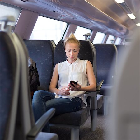 Woman workin on smart phone while traveling by train. Business travel concept. Stock Photo - Budget Royalty-Free & Subscription, Code: 400-08695026