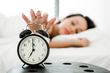 simsearch:400-08299475,k - Beautiful young woman waking up with the alarm clock Stock Photo - Budget Royalty-Free & Subscription, Code: 400-08695057