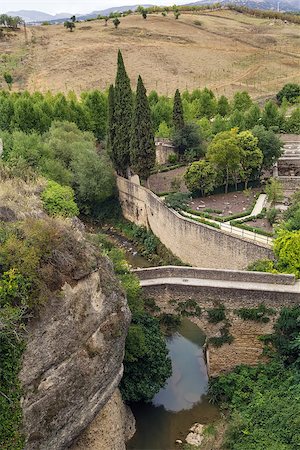simsearch:400-07209028,k - The Roman bridge in Ronda is the original bridge over the River Guadalevin and a typical single arch stone bridge, Spain Stock Photo - Budget Royalty-Free & Subscription, Code: 400-08695317