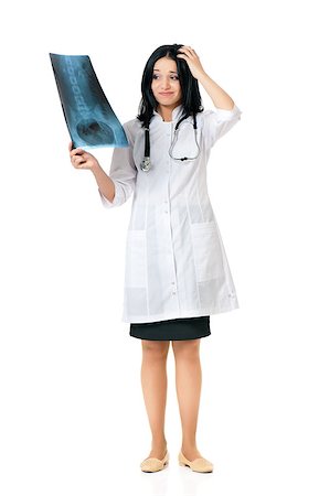simsearch:400-06634198,k - Young female doctor looking at the x-ray picture, isolated over white background Stock Photo - Budget Royalty-Free & Subscription, Code: 400-08695674