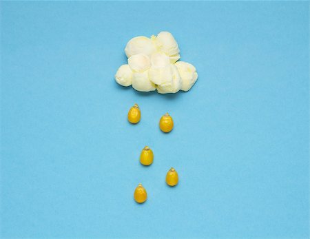 popcorn still life - Creative concept photo of popcorn with seeds falling down on blue background. Stock Photo - Budget Royalty-Free & Subscription, Code: 400-08695715