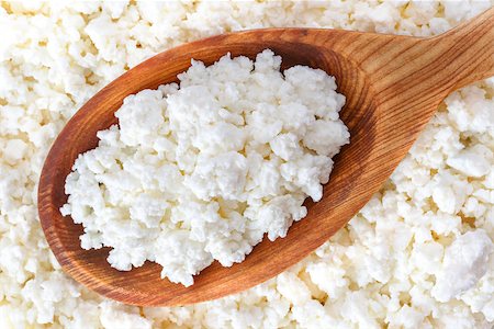 crumbly cottage cheese in the wooden spoon lying diagonally upwards Stock Photo - Budget Royalty-Free & Subscription, Code: 400-08695945