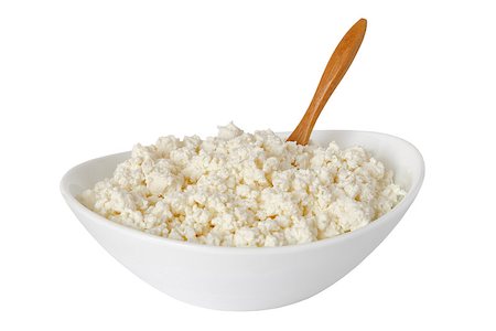 cottage cheese with the wooden spoon in a white bowl isolated on a white background - with clipping path Photographie de stock - Aubaine LD & Abonnement, Code: 400-08695943