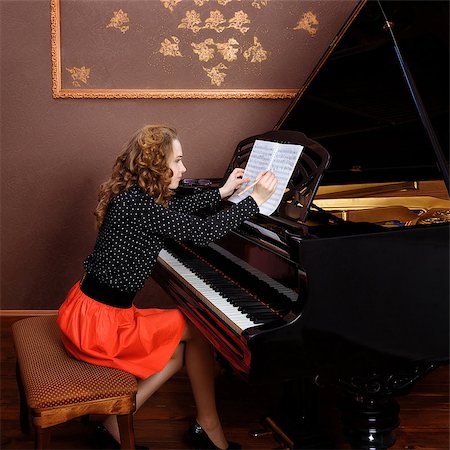 simsearch:400-09115438,k - Young woman musician writes in music book pencil. Sitting in front of grand piano. Foto de stock - Super Valor sin royalties y Suscripción, Código: 400-08695983