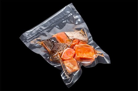 vacuum packaged pieces of salmon on the black background Stock Photo - Budget Royalty-Free & Subscription, Code: 400-08696159
