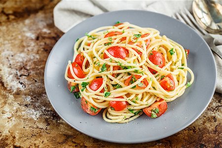 delicious pasta - Spaghetti pasta with cherry tomatoes and parsley on rustric background Stock Photo - Budget Royalty-Free & Subscription, Code: 400-08696522