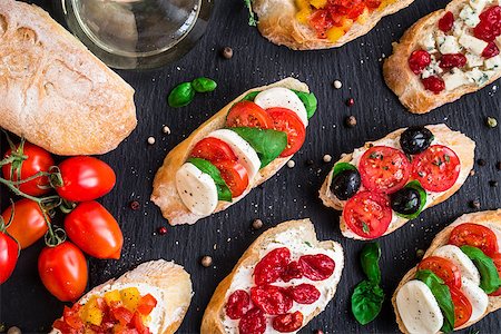 sandwich rustic table - Italian bruschetta with cherry tomatoes, herbs, olives, mozzarella on toasted crusty ciabatta bread Stock Photo - Budget Royalty-Free & Subscription, Code: 400-08693014