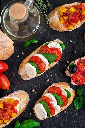 Italian bruschetta with tomatoes, mozzarella cheese and herbs Stock Photo - Budget Royalty-Free & Subscription, Code: 400-08693015