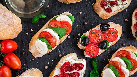 sandwich rustic table - Italian bruschetta with cherry tomatoes, herbs, olives, mozzarella on toasted crusty ciabatta bread Stock Photo - Budget Royalty-Free & Subscription, Code: 400-08693016