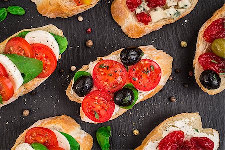 sandwich rustic table - Italian bruschetta with cherry tomatoes, herbs, olives, mozzarella on toasted crusty ciabatta bread Stock Photo - Budget Royalty-Free & Subscription, Code: 400-08693017