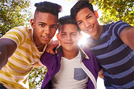 Youth culture, young people, group of male friends, multi-ethnic teens outdoors, teenagers together in park. Portrait of happy boys smiling, kids looking at camera. Slow motion Stock Photo - Budget Royalty-Free & Subscription, Code: 400-08705712