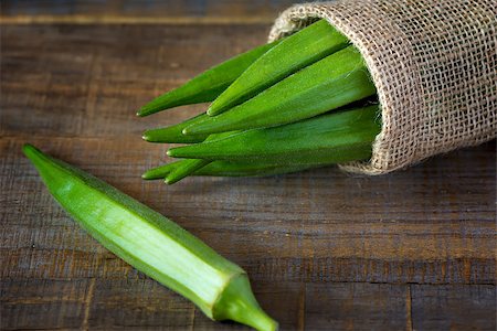 A heap of raw okra or Lady's fingers or gumbo  in a bagon wooden background Foto de stock - Royalty-Free Super Valor e Assinatura, Número: 400-08705782