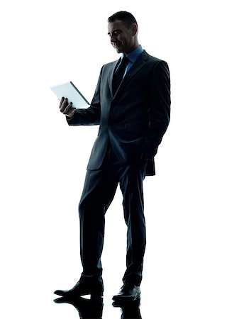 simsearch:400-08317008,k - one caucasian business man standing using digital tablet  silhouette isolated on white background Stockbilder - Microstock & Abonnement, Bildnummer: 400-08706323