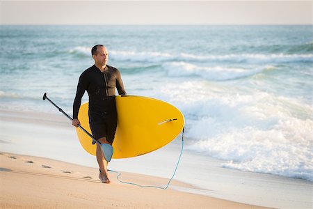 paddle board man - man with his paddle board on the beach at sunset. Stock Photo - Budget Royalty-Free & Subscription, Code: 400-08706426