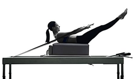 pilates reformer - one caucasian woman exercising pilates reformer exercises fitness in silhouette isolated on white backgound Foto de stock - Super Valor sin royalties y Suscripción, Código: 400-08706510