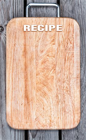 Top view of wooden cutting board on old wooden table Stock Photo - Budget Royalty-Free & Subscription, Code: 400-08706898