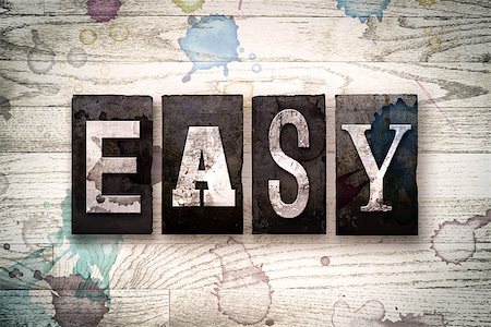 simsearch:400-08709089,k - The word "EASY" written in vintage dirty metal letterpress type on a whitewashed wooden background with ink and paint stains. Stock Photo - Budget Royalty-Free & Subscription, Code: 400-08707719