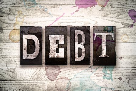 student loan - The word "DEBT" written in vintage dirty metal letterpress type on a whitewashed wooden background with ink and paint stains. Stock Photo - Budget Royalty-Free & Subscription, Code: 400-08707713