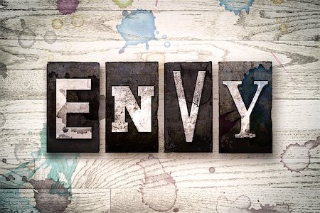 simsearch:400-08709089,k - The word "ENVY" written in vintage dirty metal letterpress type on a whitewashed wooden background with ink and paint stains. Foto de stock - Royalty-Free Super Valor e Assinatura, Número: 400-08707720
