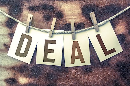 simsearch:400-08290801,k - The word "DEAL" stamped on cards and pinned to an old piece of twine over a rusted metal background. Stock Photo - Budget Royalty-Free & Subscription, Code: 400-08707919