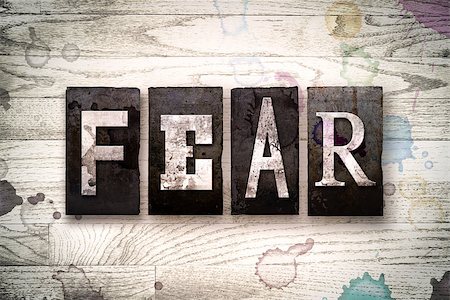 simsearch:400-08709089,k - The word "FEAR" written in vintage dirty metal letterpress type on a whitewashed wooden background with ink and paint stains. Foto de stock - Royalty-Free Super Valor e Assinatura, Número: 400-08707930