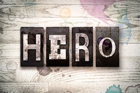 The word "HERO" written in vintage dirty metal letterpress type on a whitewashed wooden background with ink and paint stains. Stock Photo - Budget Royalty-Free & Subscription, Code: 400-08707942