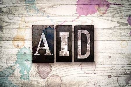 simsearch:400-08709089,k - The word "AID" written in vintage, dirty metal letterpress type on a whitewashed wooden background with ink and paint stains. Foto de stock - Royalty-Free Super Valor e Assinatura, Número: 400-08709082