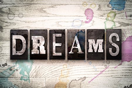 simsearch:400-08709089,k - The word "DREAMS" written in vintage, dirty metal letterpress type on a whitewashed wooden background with ink and paint stains. Foto de stock - Royalty-Free Super Valor e Assinatura, Número: 400-08709100